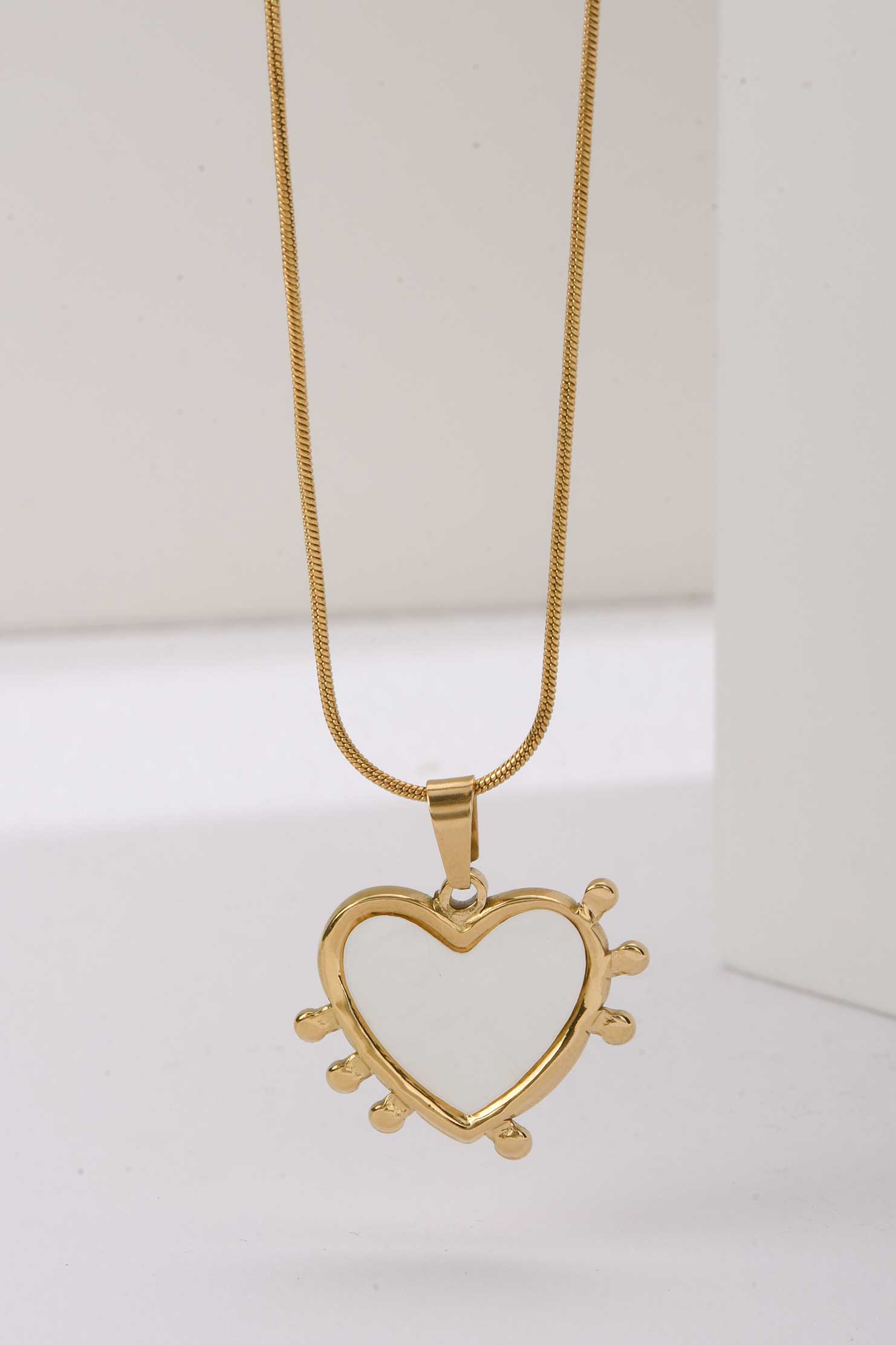 Stainless Steel Necklace | Heart-Shaped Gold Pendant with White Enamel & Radiant Spikes Accessories Accessories - Cizaro Jeans
